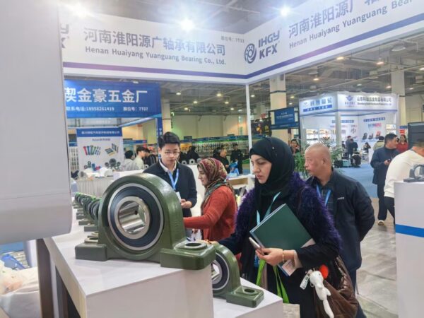 A business person inspecting a pillow block bearing