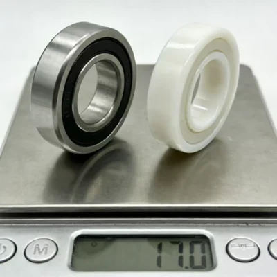 A stainless steel bearing and a ceramic bearing on a scale