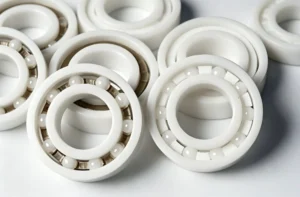 White ceramic ball bearings with visible rolling elements arranged closely on a surface, showcasing their design and structure.
