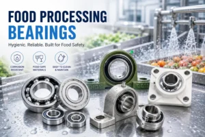 Various corrosion-resistant and hygienic bearings displayed on a wet stainless-steel surface, suitable for food processing environments with a background of produce being washed.